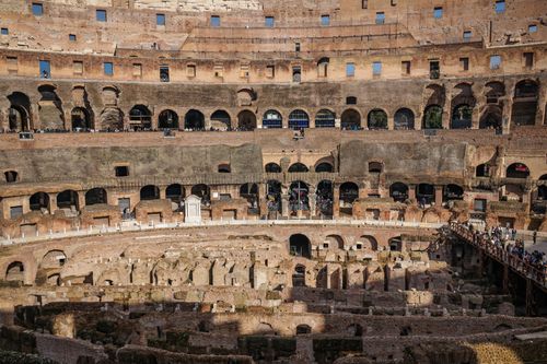 Free Explore the ancient Roman Colosseum with this stunning interior view, capturing architectural grandeur. Stock Photo
