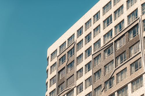 Free Close-up of a modern building facade under a clear sky in Hong Kong. Stock Photo