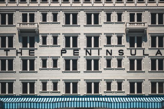Close-up of The Peninsula Hotel facade in Hong Kong showcasing its unique architectural design.