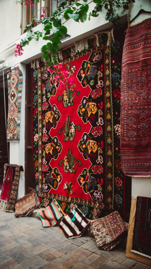 Free Vibrant display of traditional carpets in a market setting, showcasing rich colors and patterns. Stock Photo