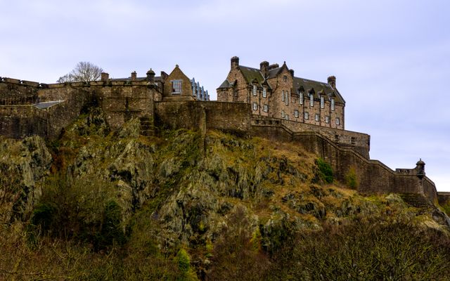 Photo: Igor Passchier on Pexels Edinburgh Castle perched on a rocky hill under a cloudy sky, showcasing Scotland's rich heritage.