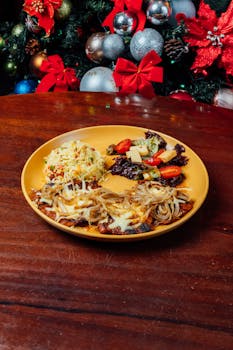 Ecuadorian dish with grilled steak, rice, onions, and salad in festive Christmas decor.