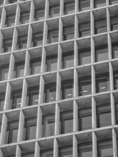 Free A black and white image of a modern building facade with grid pattern windows in Santiago, Chile. Stock Photo