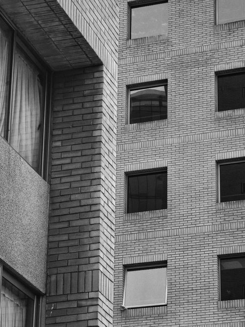 Free Black and white photo of brick building facade in Santiago, Chile showcasing geometric patterns. Stock Photo