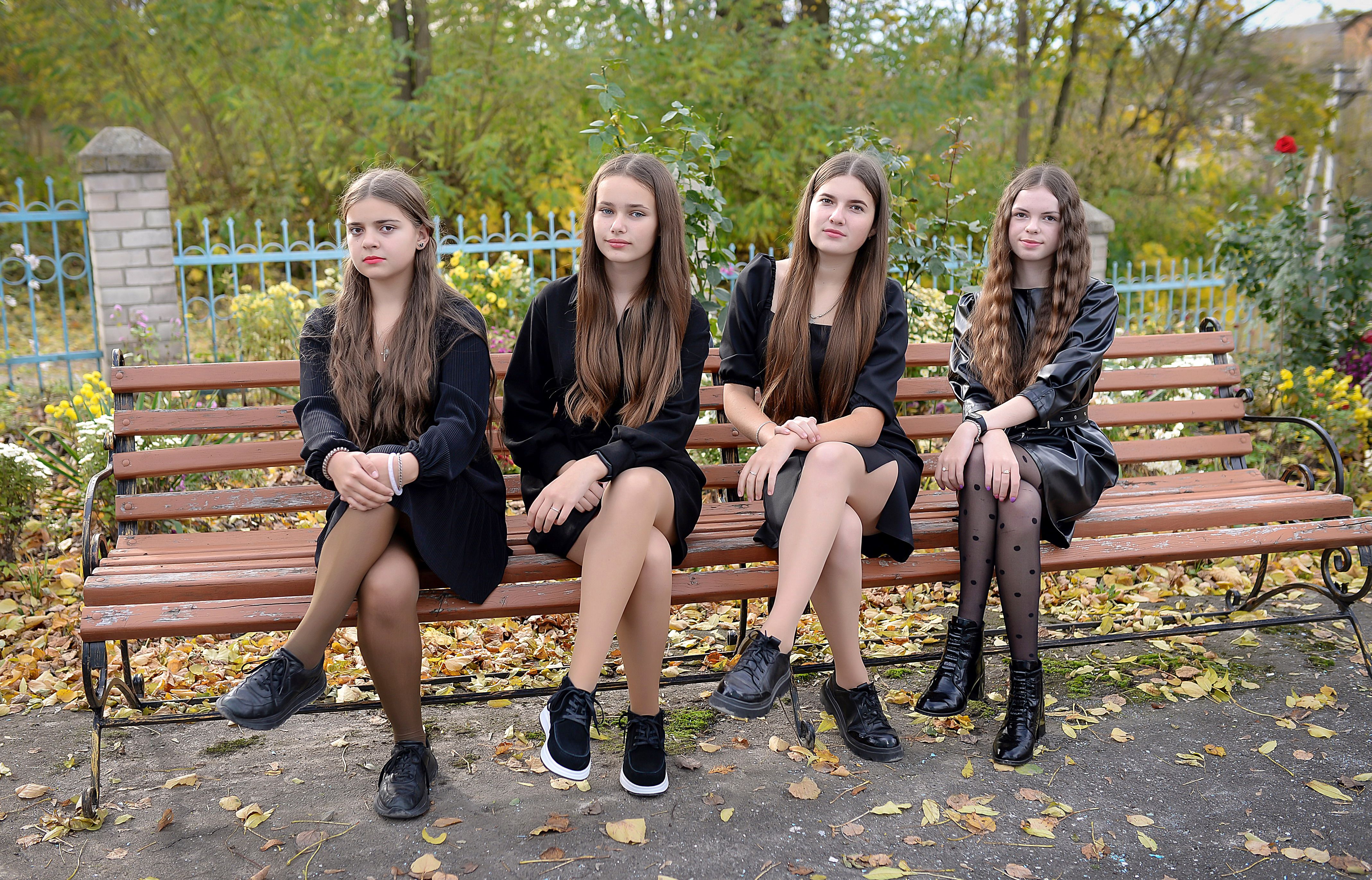 Four Teenage Girls Sitting on Park Bench · Free Stock Photo