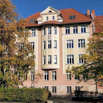 Charming European architecture surrounded by autumn trees, showcasing a picturesque urban scene.