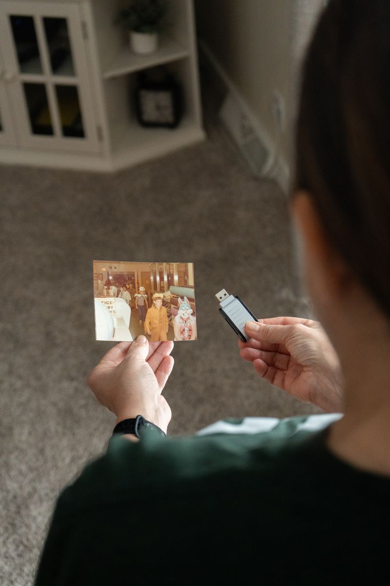 USB Drive with Vintage Family Photos on Carpet · Free Stock Photo