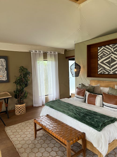 Free Spacious bedroom with modern decor, featuring neutral tones, natural light, and stylish furnishings, ideal for relaxation. Stock Photo