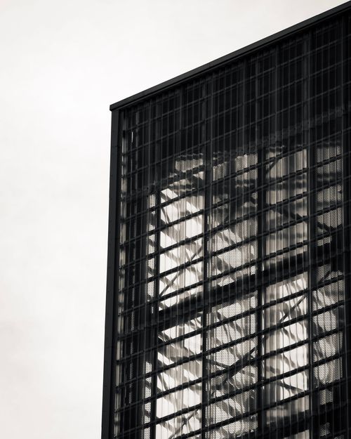 Free Minimalist black and white photo of a building facade with geometric patterns. Stock Photo
