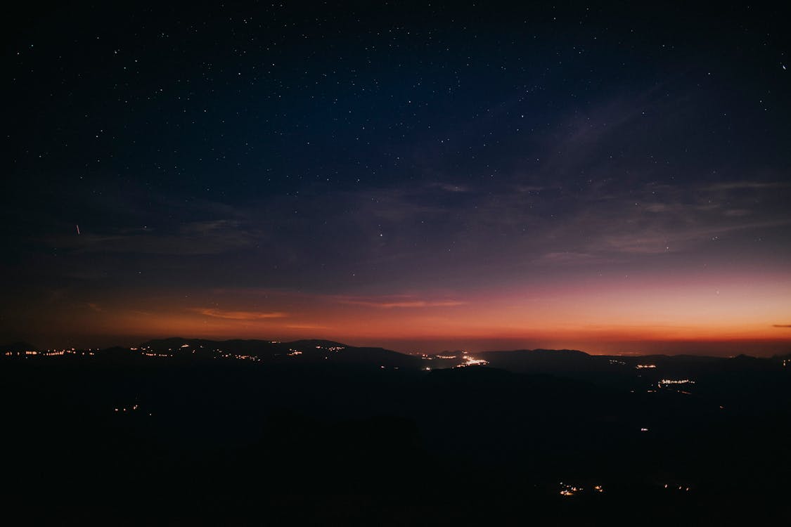 Silhouette Photography of Mountain Range during Nighttime