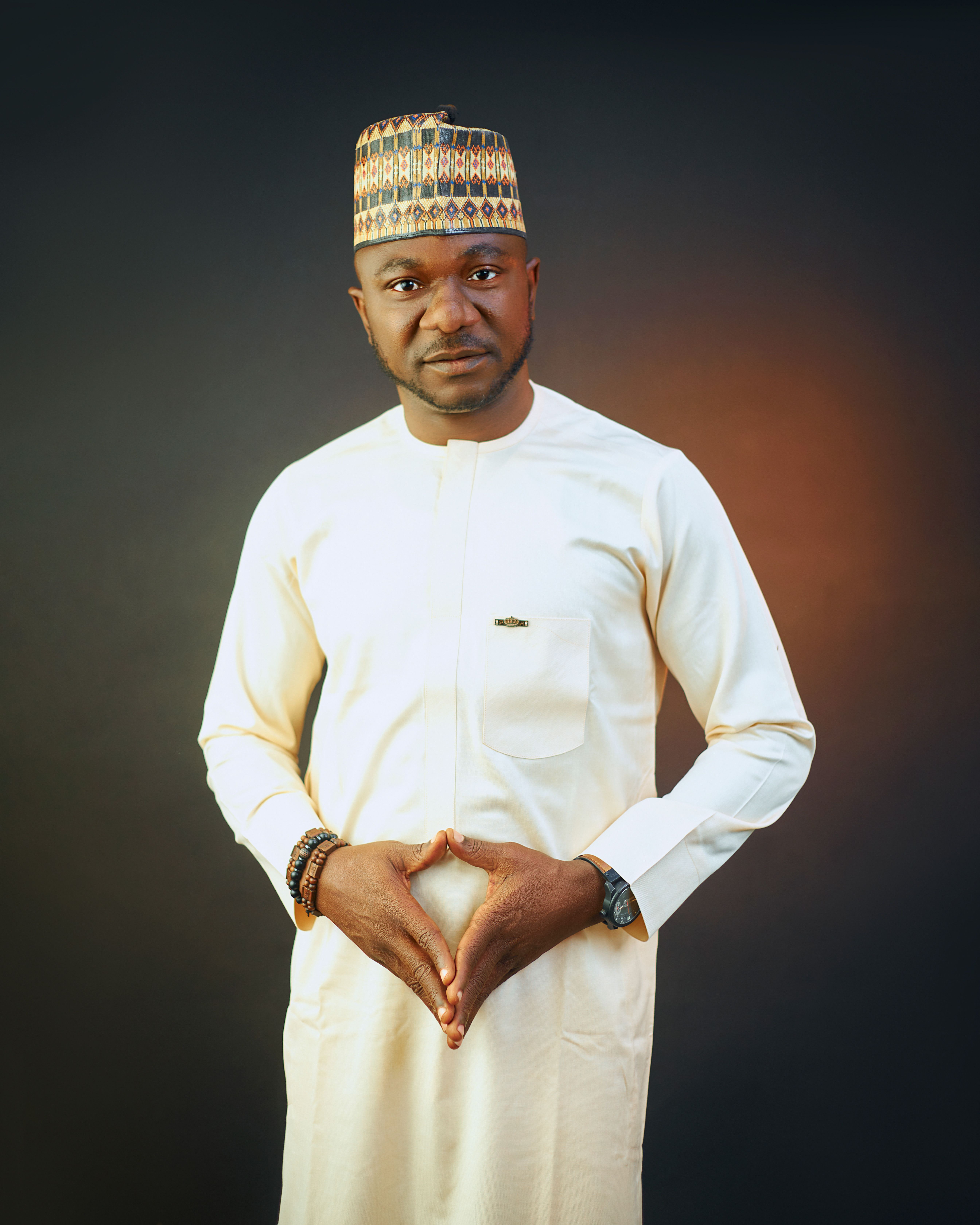 Portrait of an African man in traditional attire with a confident pose.