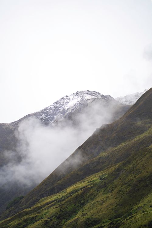 Free Serene view of a foggy mountain range in Queenstown showcasing nature's beauty. Stock Photo