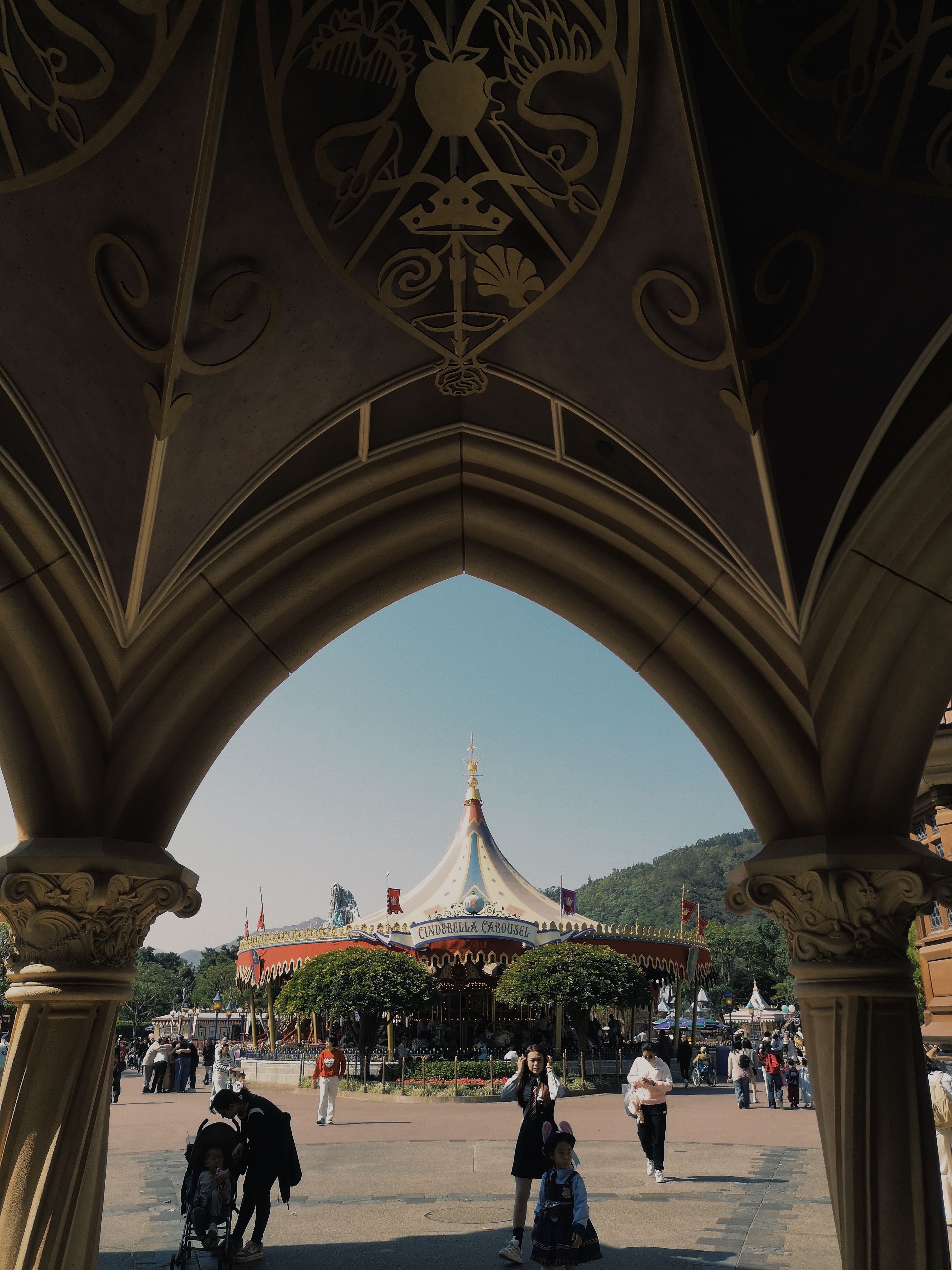 Explore the blend of gothic architecture and vibrant carousel at Hong Kong's entertainment park.