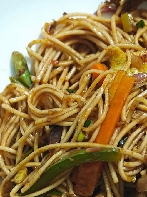 Free Close-up of stir-fried noodles with colorful vegetables, highlighting Asian cuisine. Stock Photo