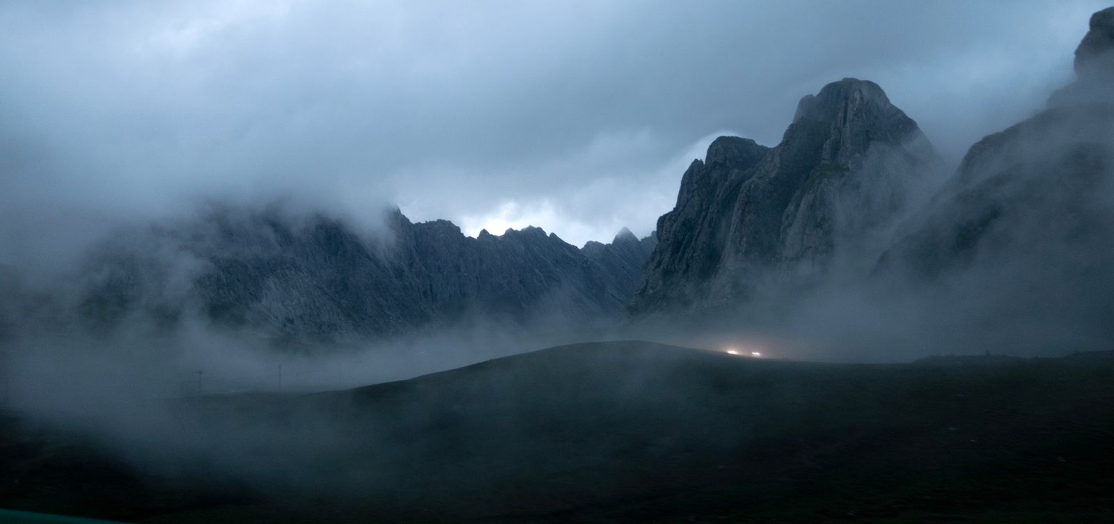 Fog-covered peaks at dusk — photo by Cencial on Pexels