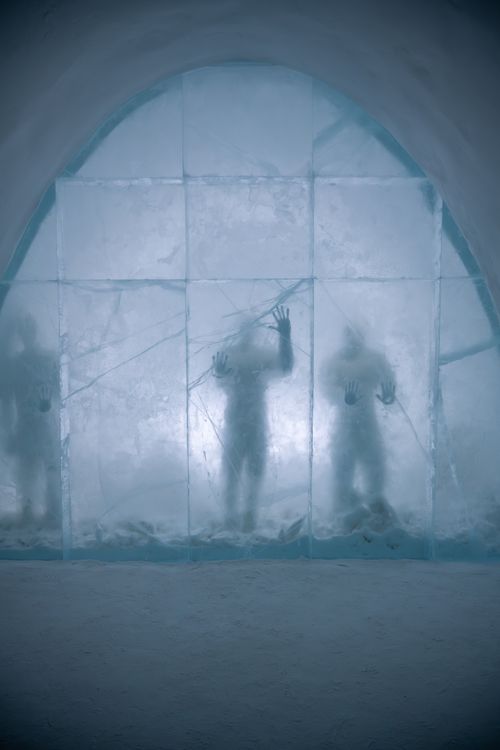 Free Eerie silhouettes of figures behind an icy wall in Kiruna, Sweden. Stock Photo