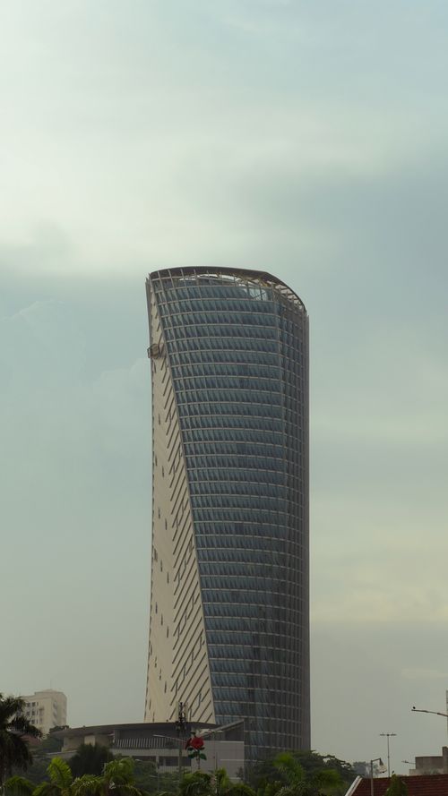 Free Towering modern skyscraper with unique curvature in Malaysia, under a soft sky. Stock Photo