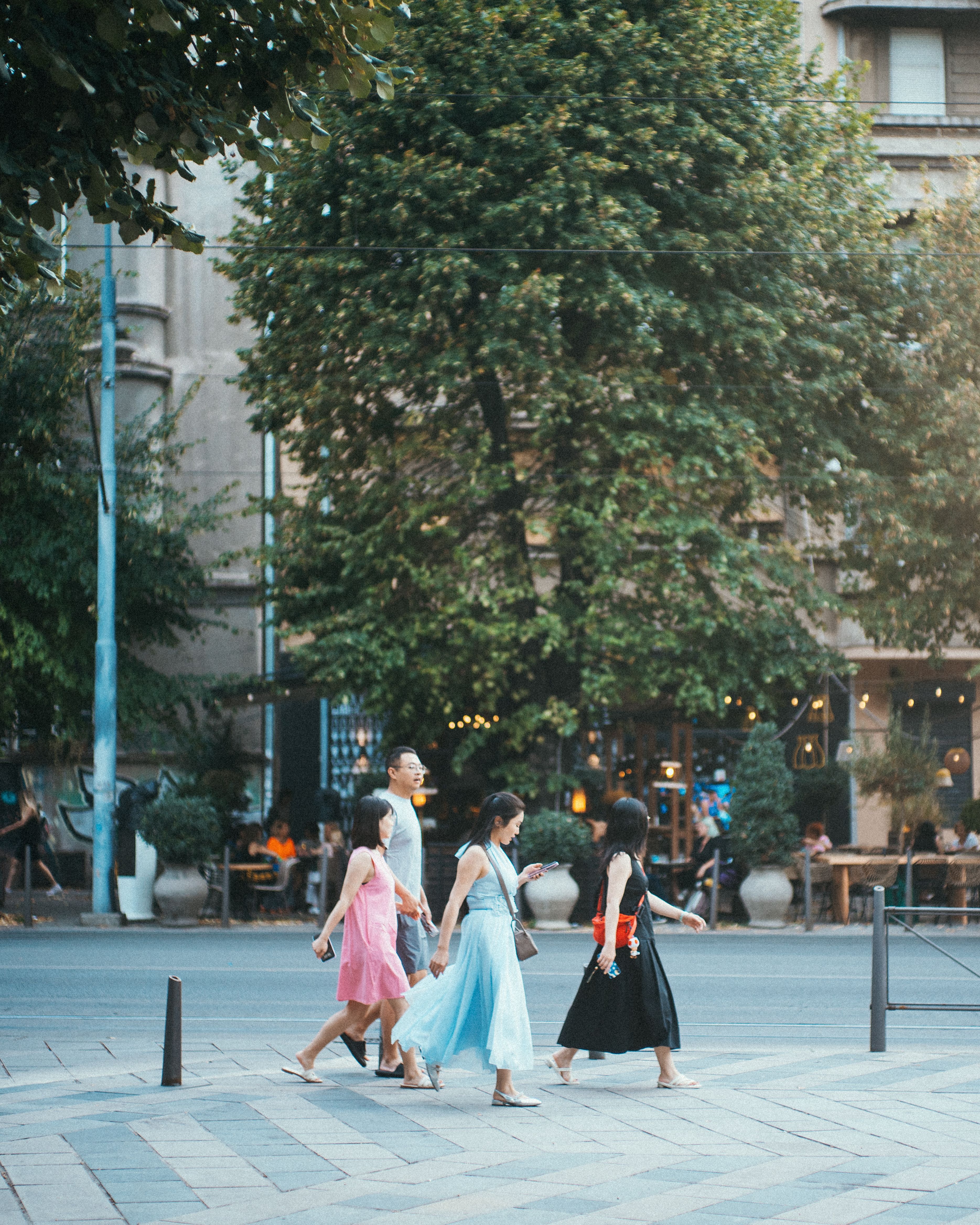Group of People Walking in Urban Park Setting · Free Stock Photo