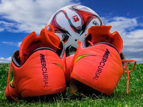 Pair of Orange Mercury Shoes on Grass