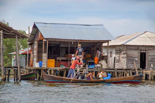 Free A lively scene at a floating village in North Sumatra, Indonesia, showcasing local culture. Stock Photo