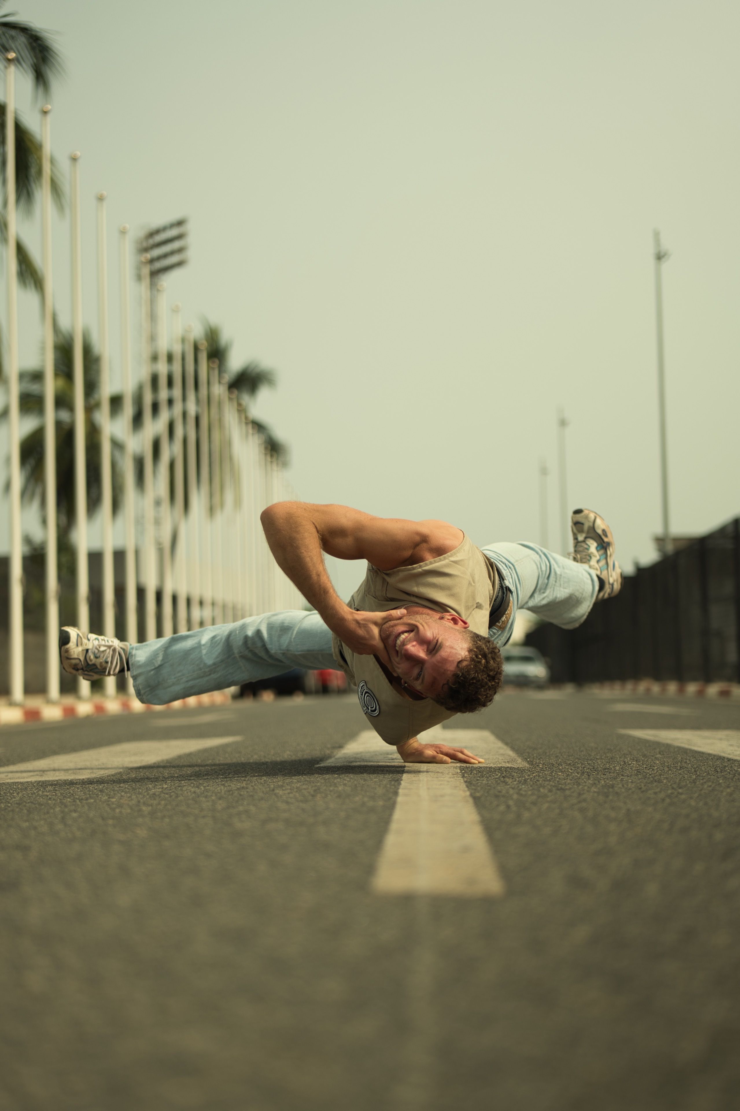 An energetic breakdancer performs a move on a street in Togo, capturing urban culture.