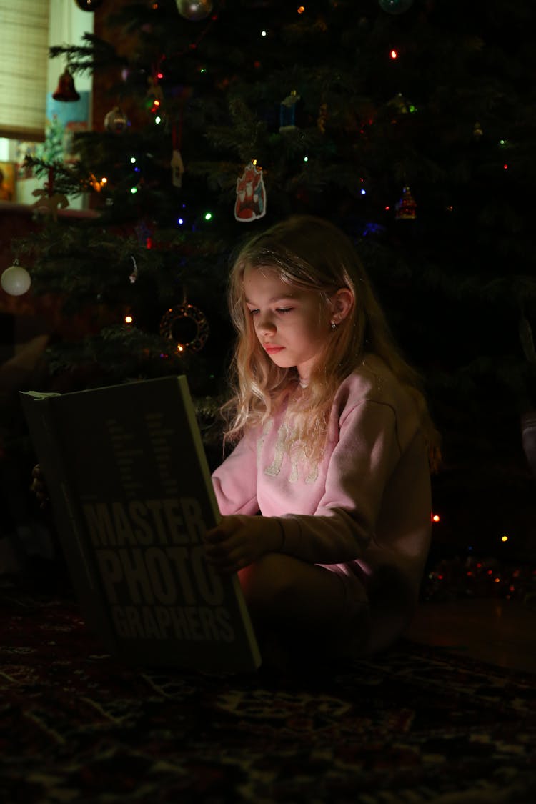 Girl In Pink Hoodie Holding Book