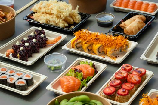 Vibrant array of sushi and Japanese dishes on a table, perfect for gourmet food lovers.