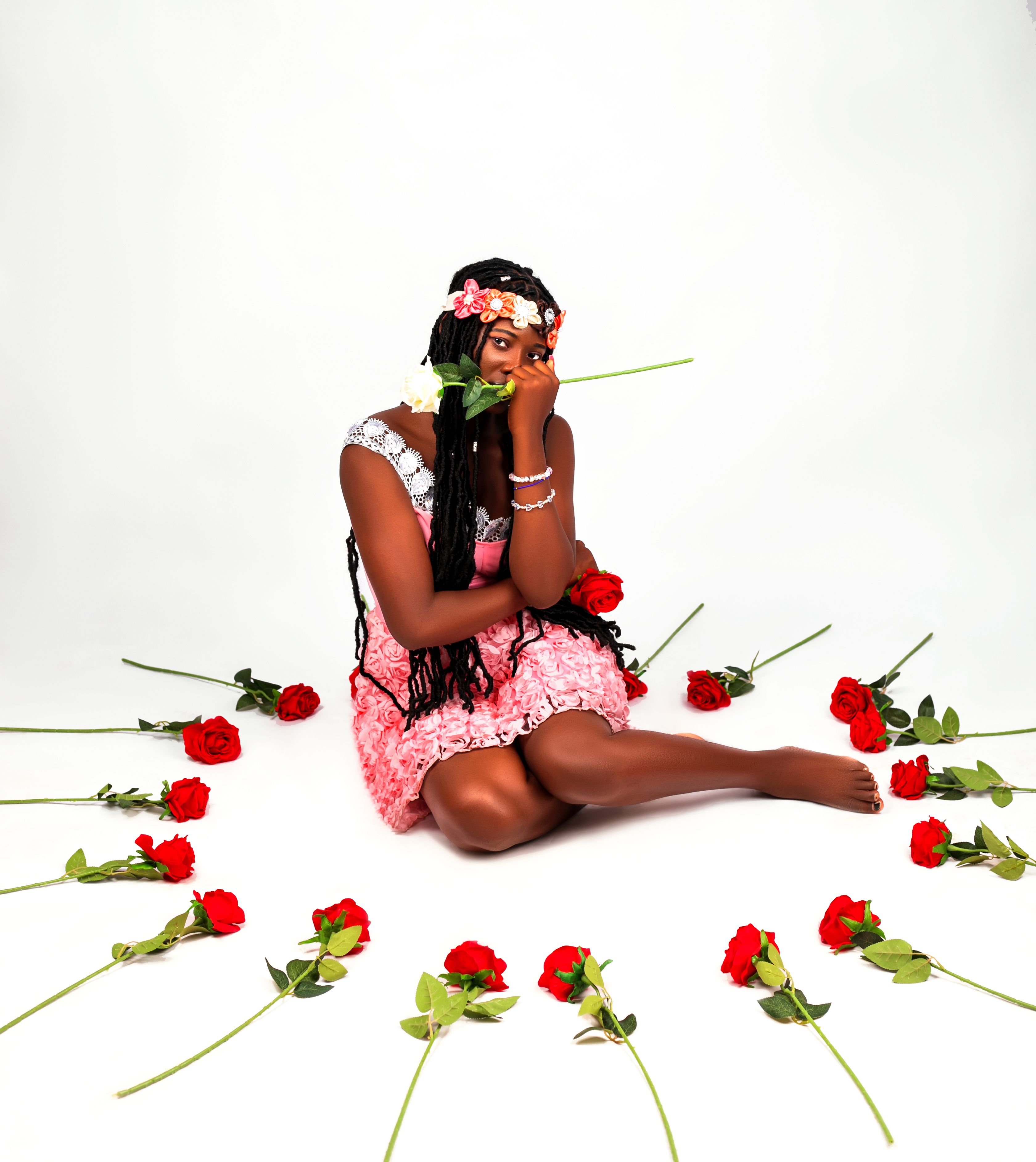 Young Woman Surrounded by Red Roses in Studio · Free Stock Photo
