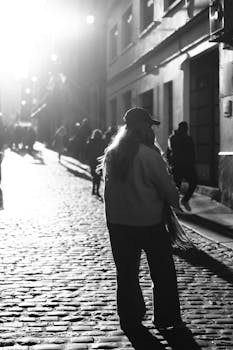 Explore the moody silhouette on a cobblestone street in Dublin's urban landscape.