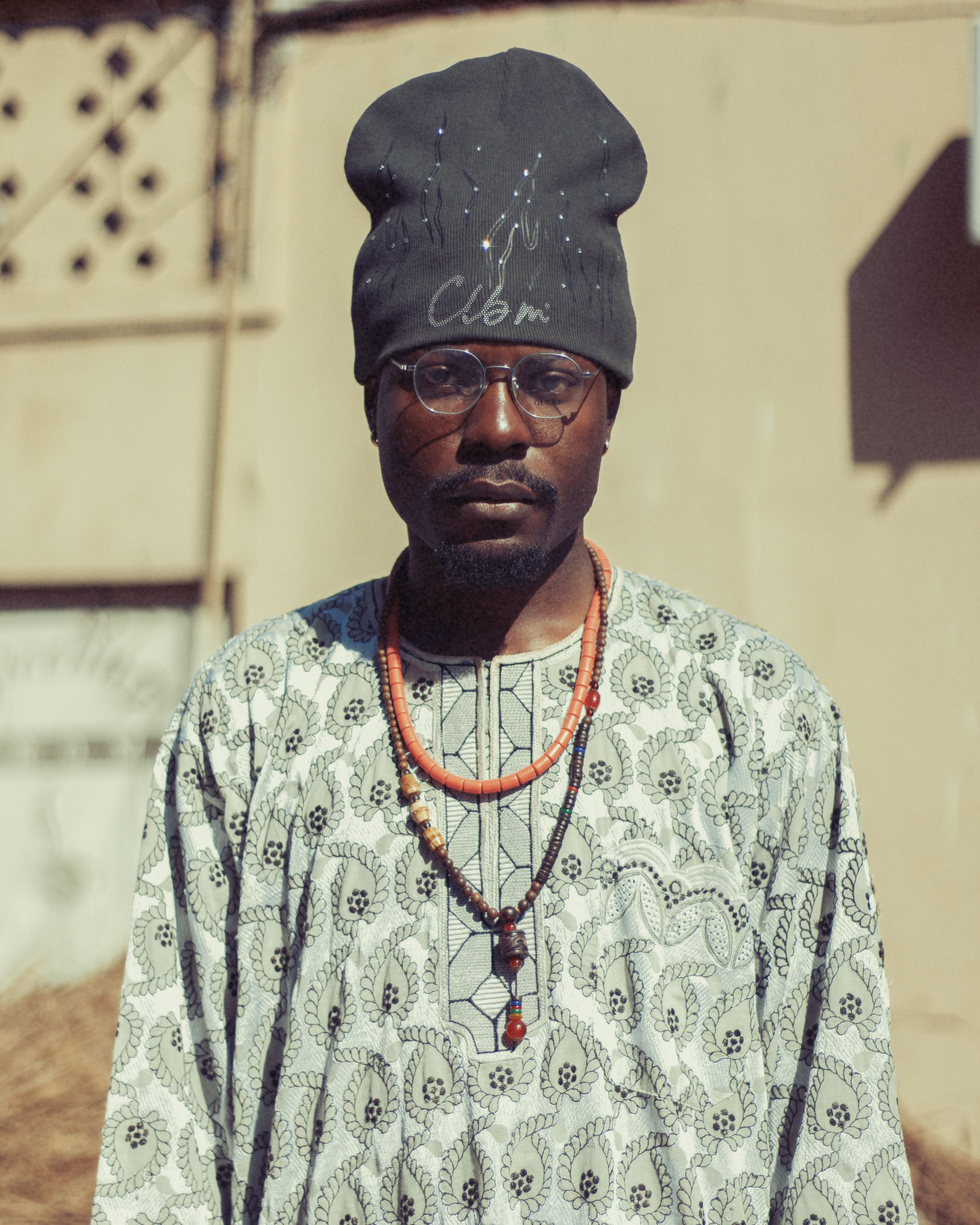 A man wearing traditional Nigerian clothing in Kano, Nigeria on a sunny day.