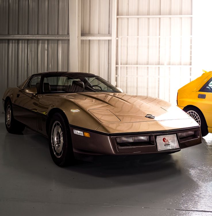 Gold Class Rides Cars Classic Gold Car in Urban Garage Setting · Free Stock Photo