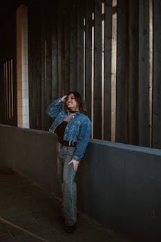 Stylish woman in denim poses against urban backdrop in Cluj-Napoca.