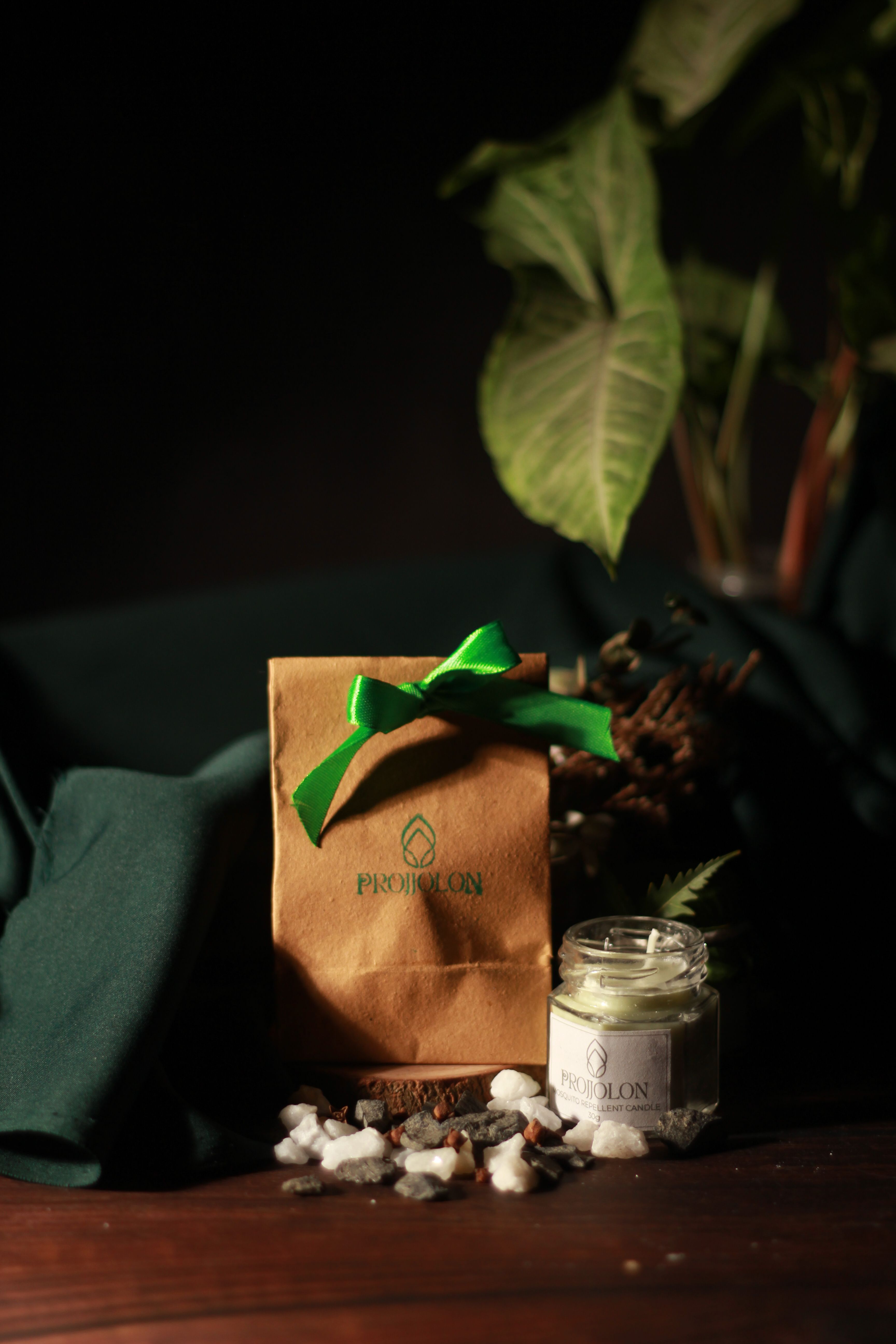 Handmade eco-friendly candle and packaging in a rustic display, shot in Dhaka, Bangladesh.