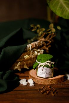A beautifully styled eco-friendly candle setup with fresh greenery and natural elements. - Fotografer Sidoarjo