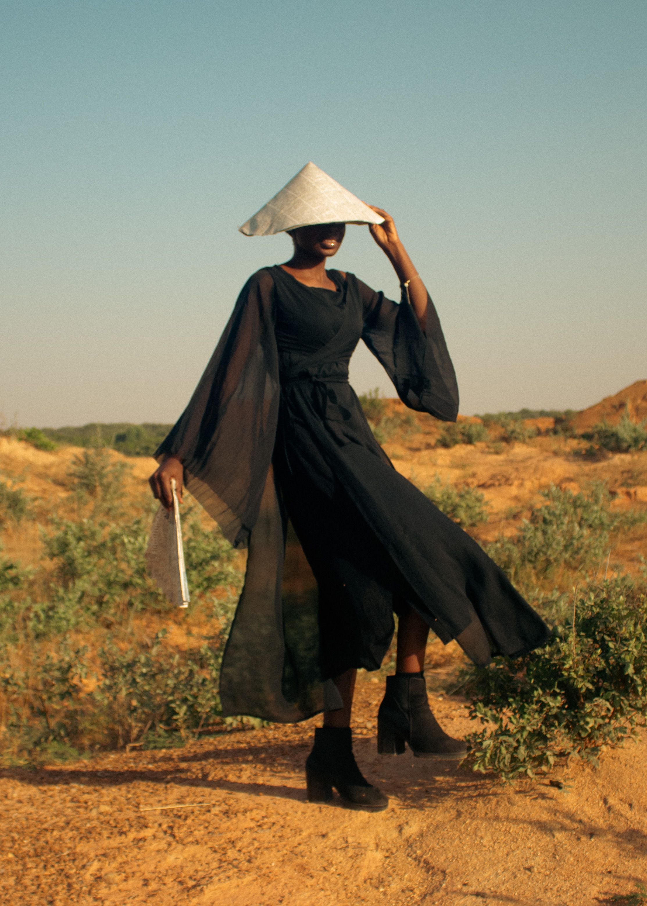Elegant Woman in Black Dress and Asian Hat Outdoors  Free Stock Photo
