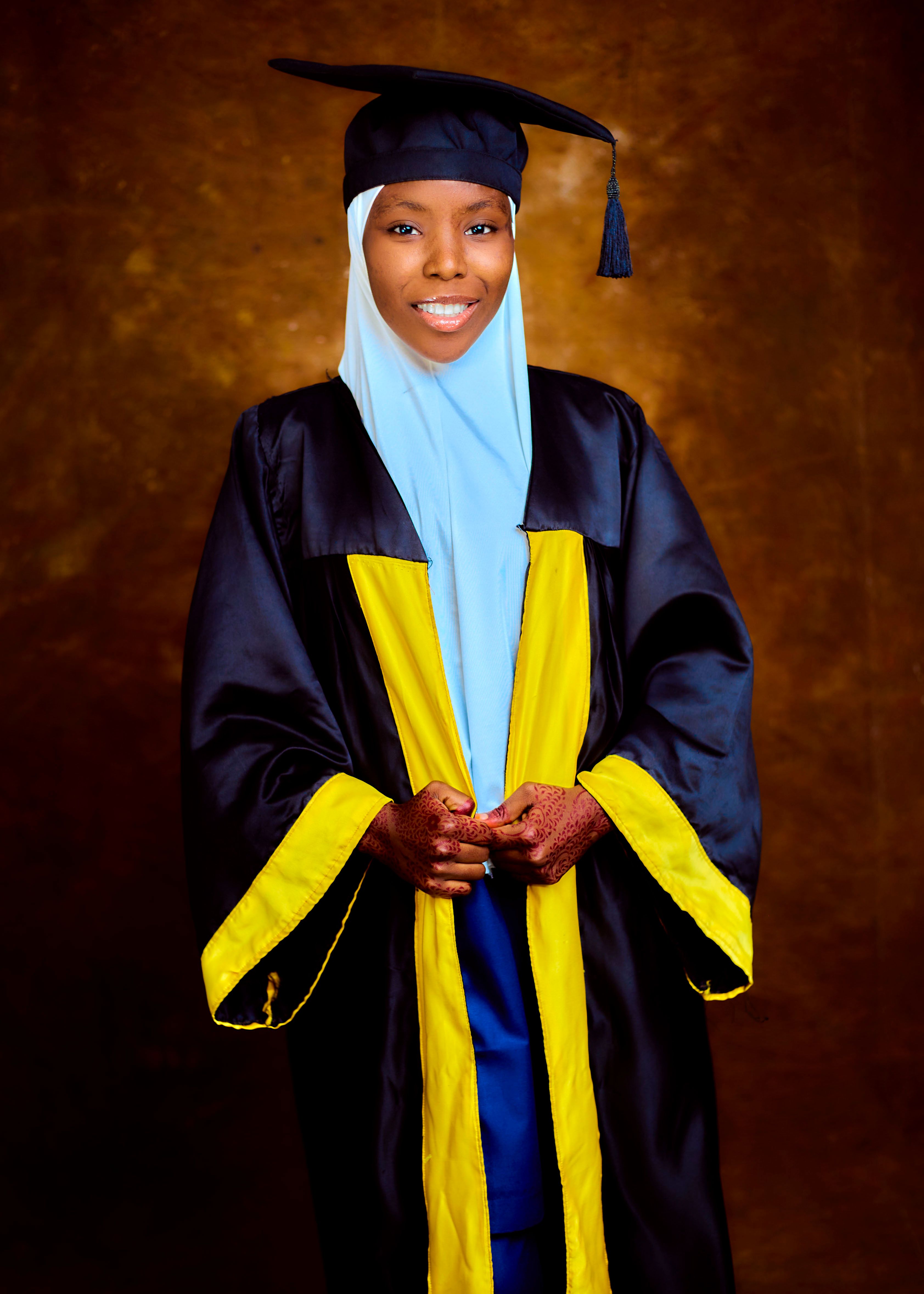 Young Muslim Woman in Graduation Gown Smiling  Free Stock Photo