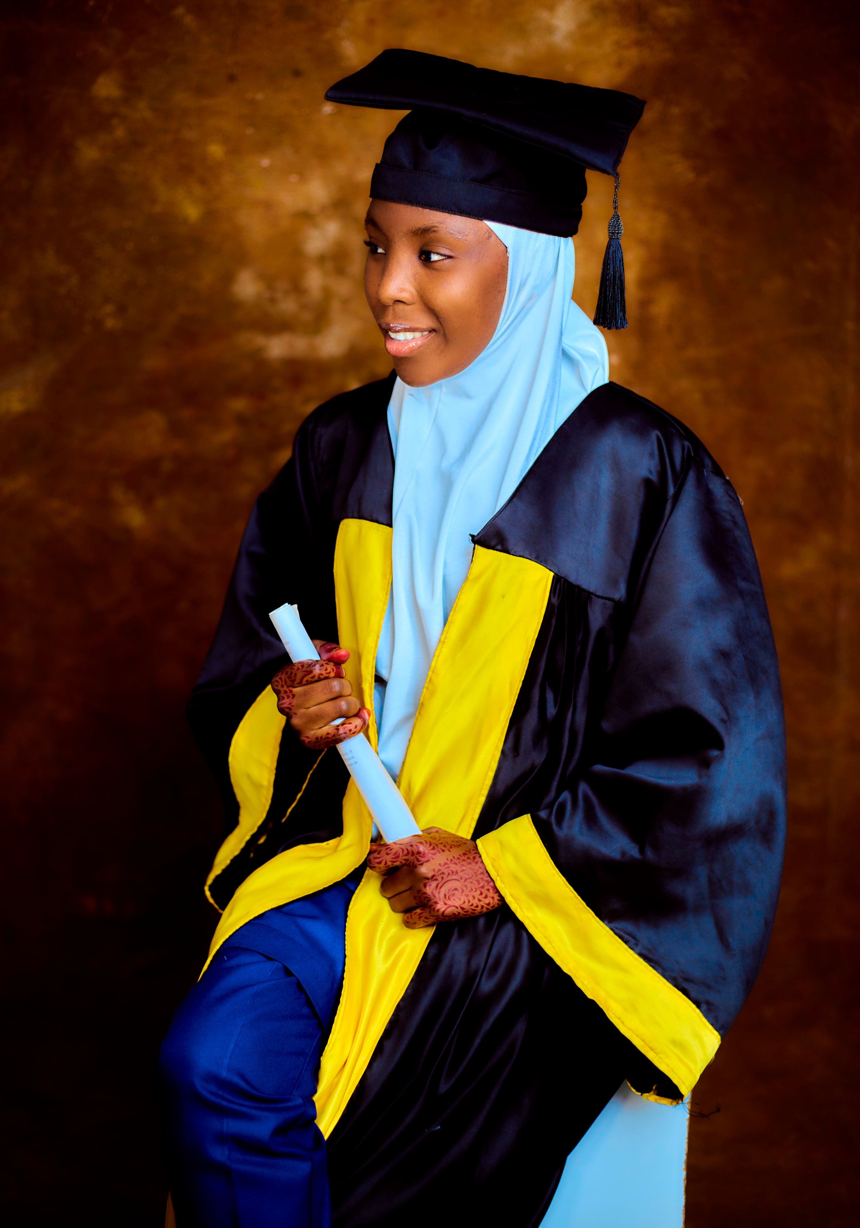 Young Muslim Woman in Graduation Gown Smiling  Free Stock Photo