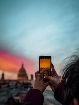 A captivating rooftop view of St. Paul's Cathedral in London during a colorful sunset.
