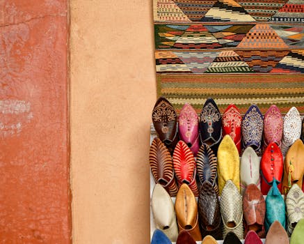 Vibrant display of handmade Moroccan slippers in a Marrakesh market, showcasing traditional patterns and colors.