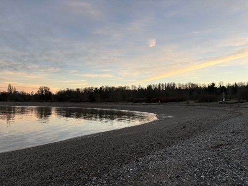 Free Scenic sunset beach view with calm waters in Vancouver, British Columbia. Stock Photo