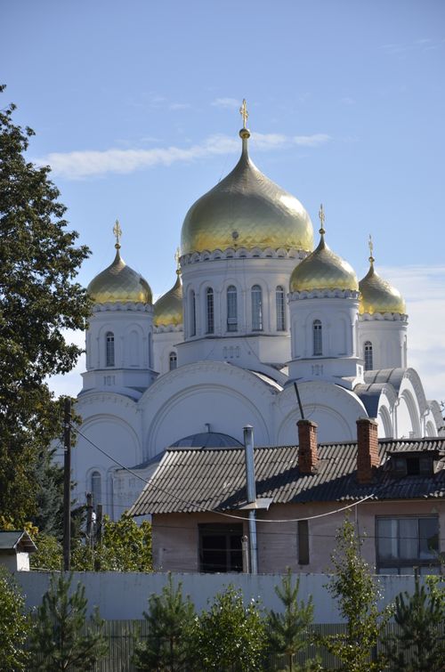 Free Beautiful view of a Russian Orthodox cathedral with golden domes under blue sky. Stock Photo