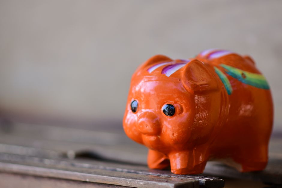 vibrant orange piggy bank representing how to save 1000 fast