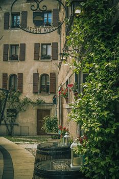 Vintage alley with ivy-covered walls and lanterns in a quaint European village, perfect for travel inspiration. — photo by Lorenza Magnaghi