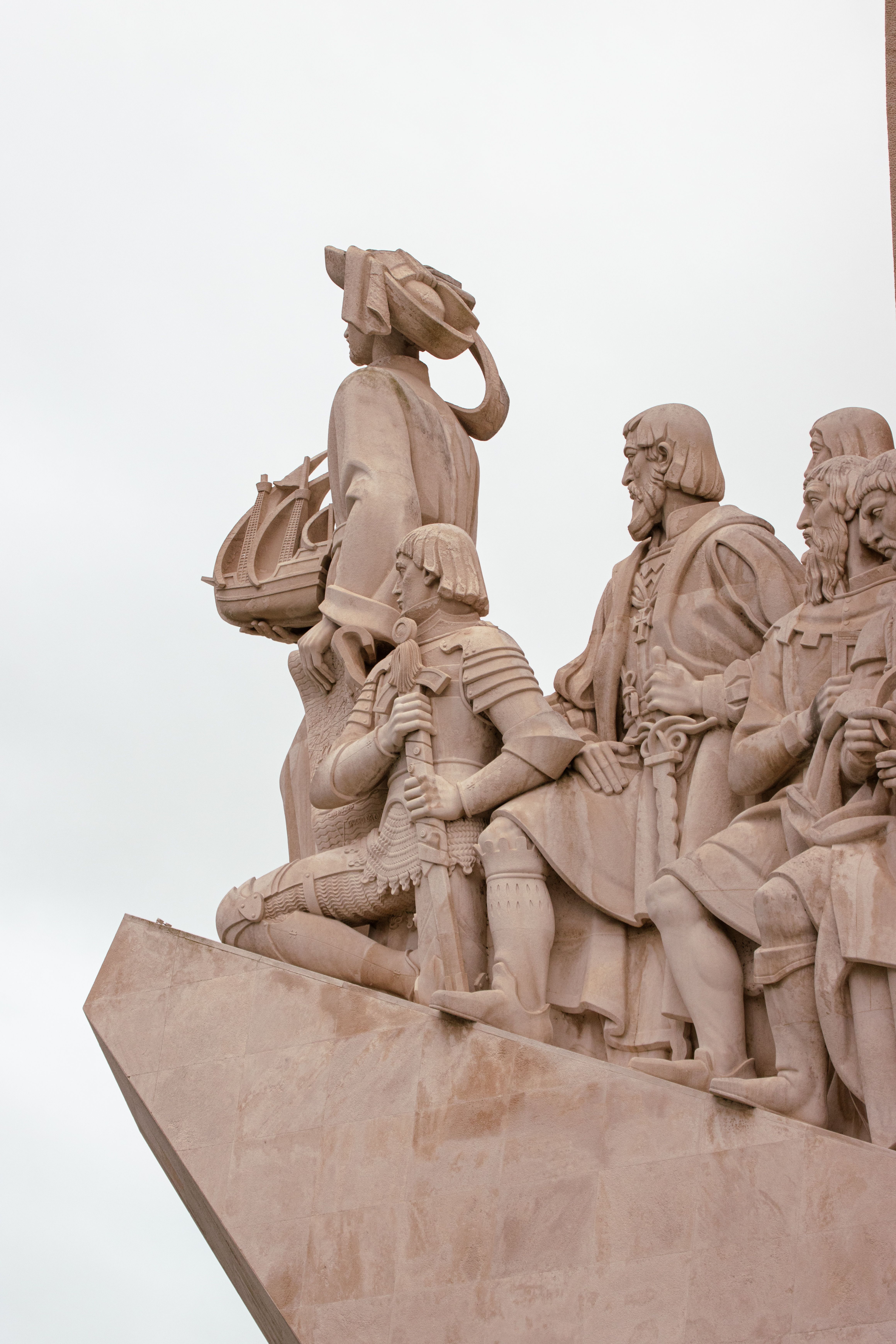 Stone sculptures of historic Portuguese explorers at Padrão dos Descobrimentos monument in Lisbon, Portugal