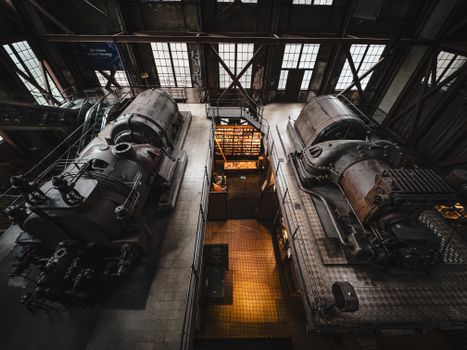 Overhead view of vintage industrial machinery inside a historic factory setting.