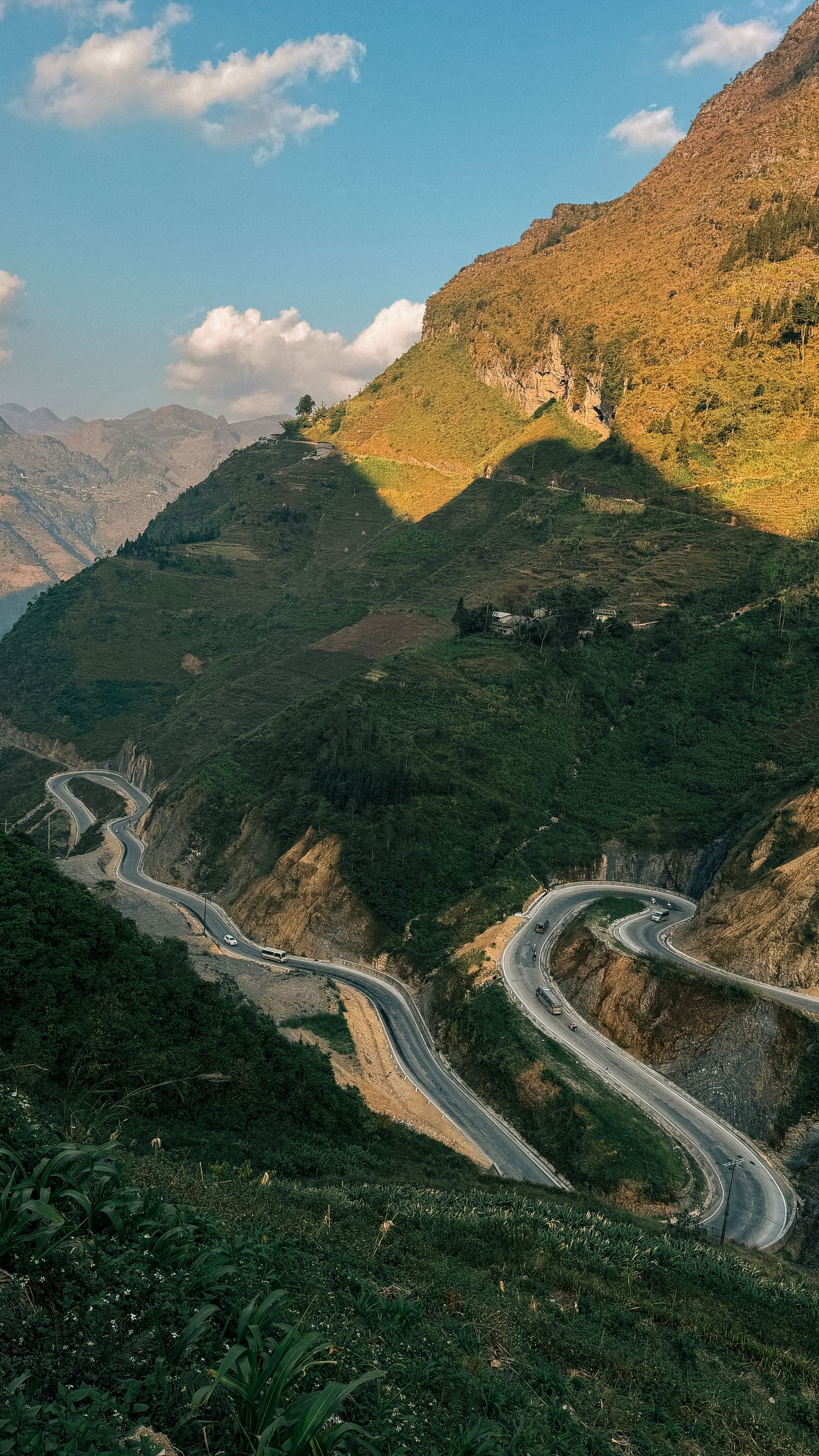 Scenic winding road through Ha Giang mountains showing the art of riding slowly