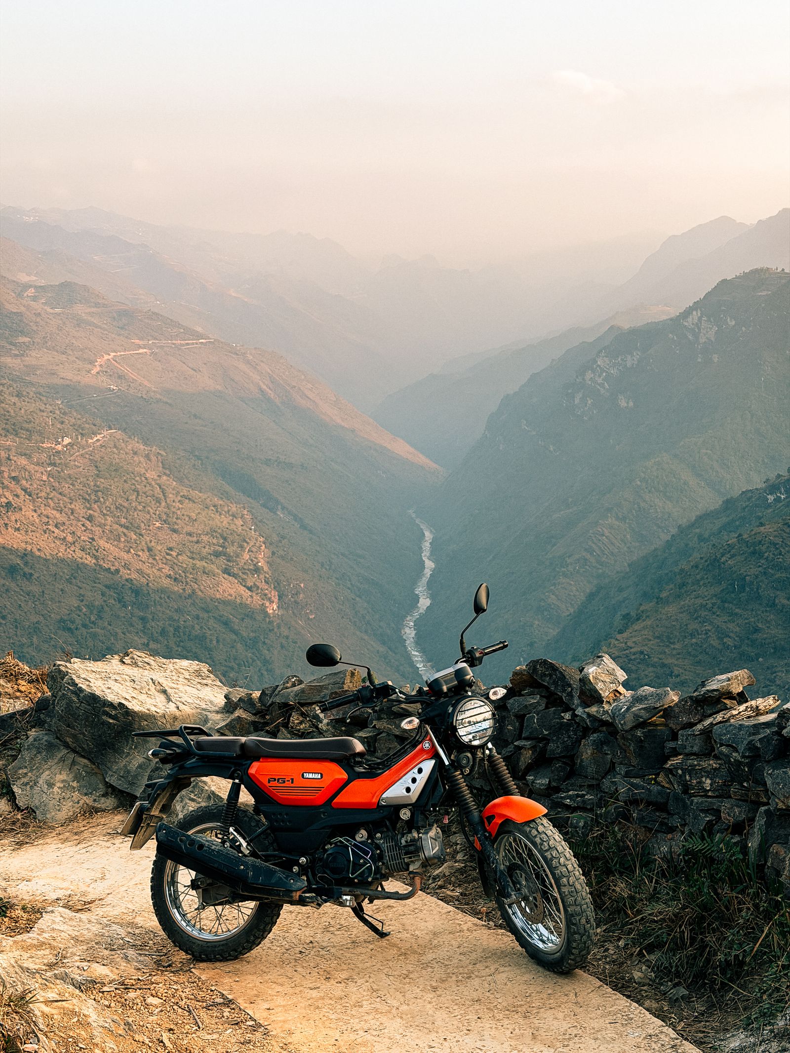 Motorbike resting on a Ha Giang mountain road with a valley view
