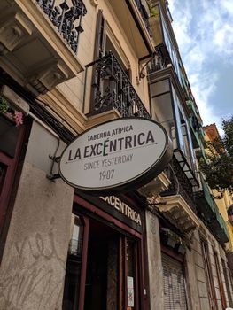 Explore the lively streets of Madrid with this view of 'La Excéntrica' tavern, showcasing European charm.
