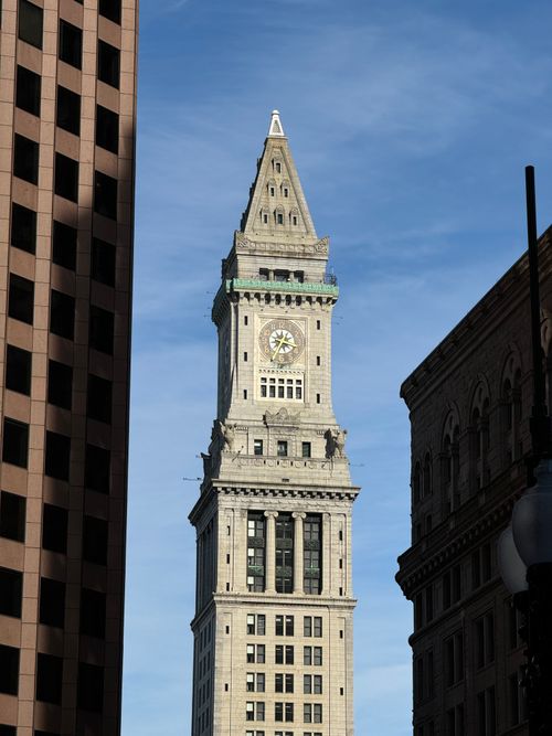 Free View of the historic Custom House Tower framed by buildings in Boston, under a clear sky. Stock Photo
