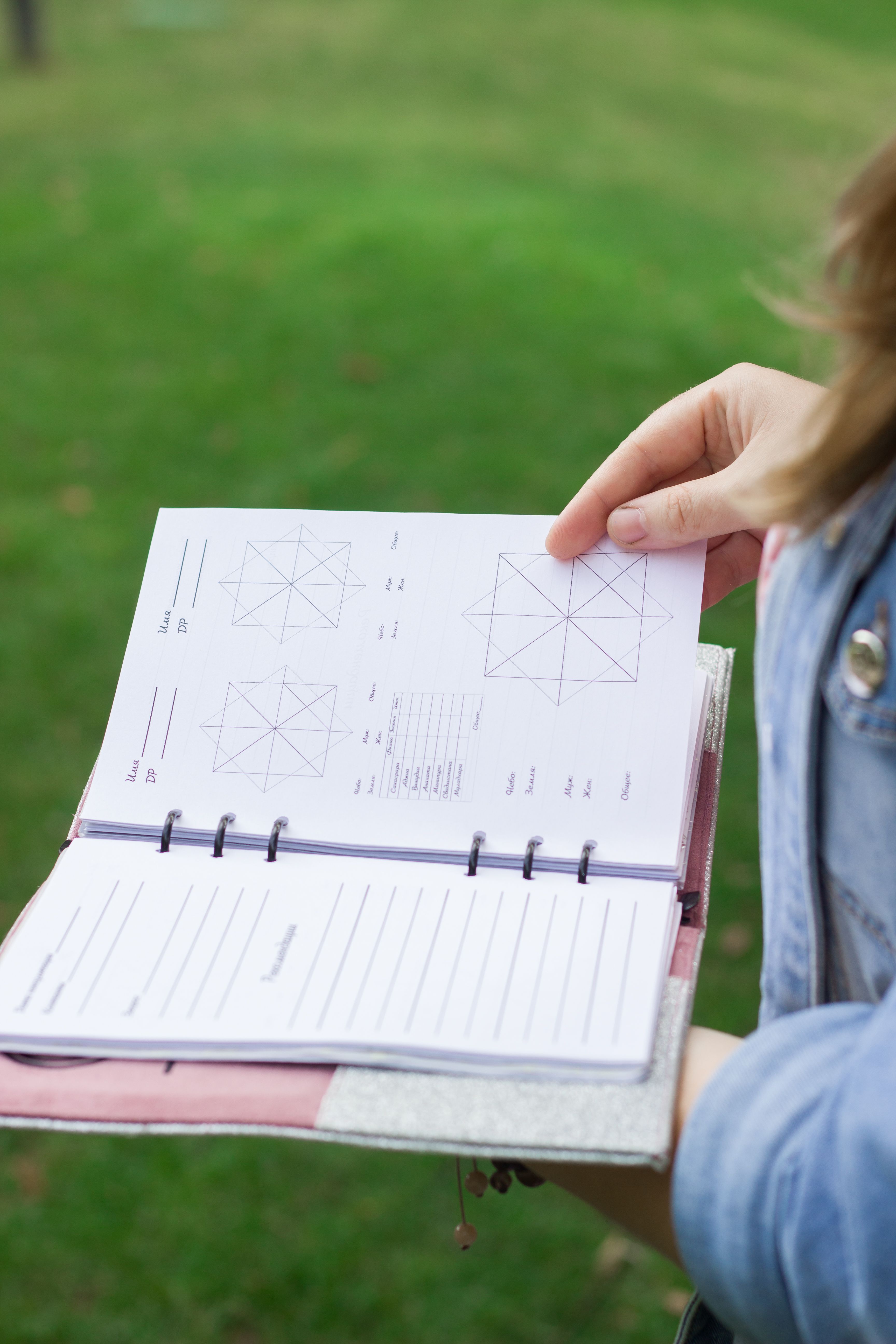 Person Holding Open Planner Outdoors · Free Stock Photo